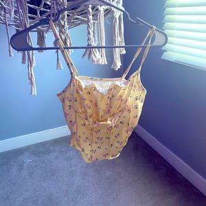 This is a yellow floral print crop tank top.
